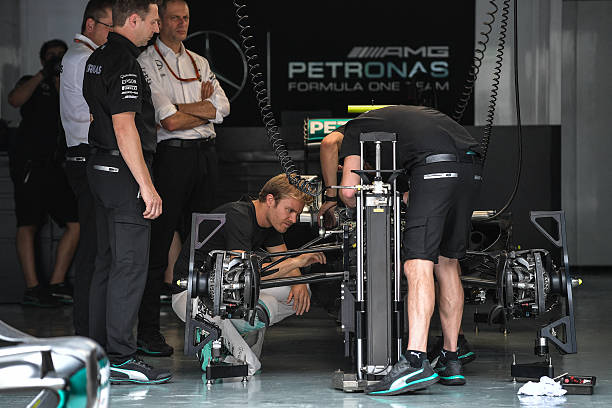 Mechanic inspecting car