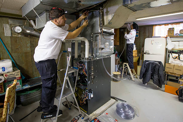 Technician servicing furnace
