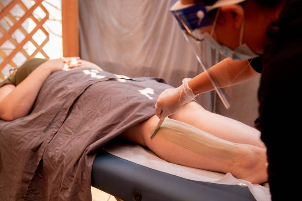 Esthetician waxing legs