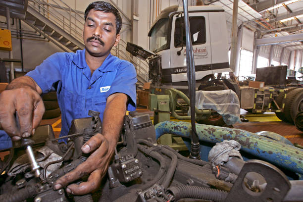 Diesel mechanic servicing truck