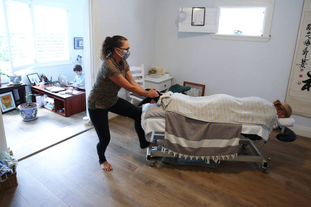 Therapist massaging client