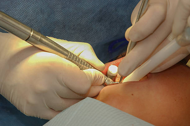 Oral surgeon examining patient