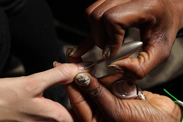 Manicurist painting nails