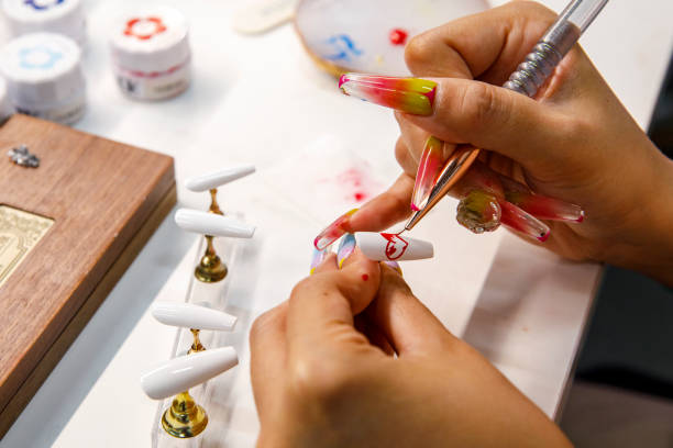 Nail technician applying press-ons