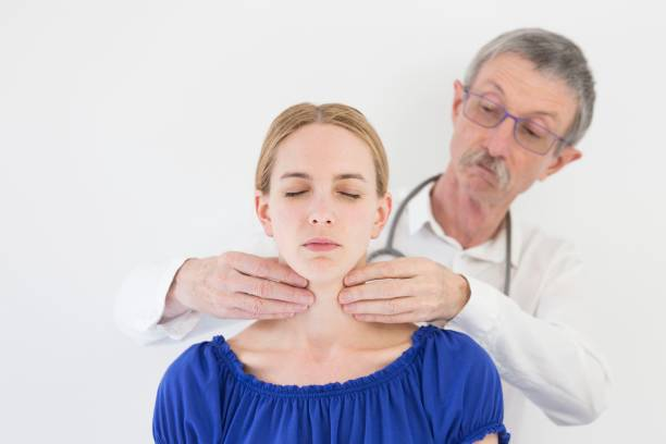 Doctor checking thyroid