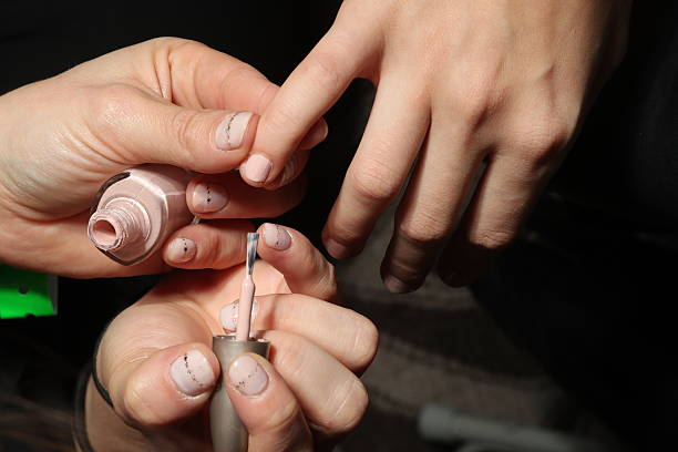 Manicurist painting nails