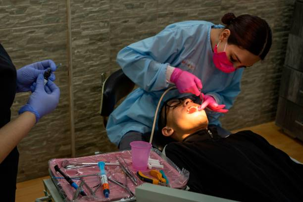 Orthodontist adjusting braces