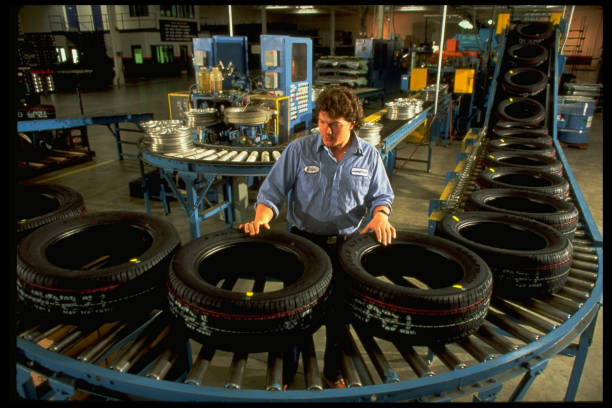 Tire shop worker displaying tires