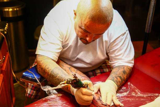 Tattoo artist working