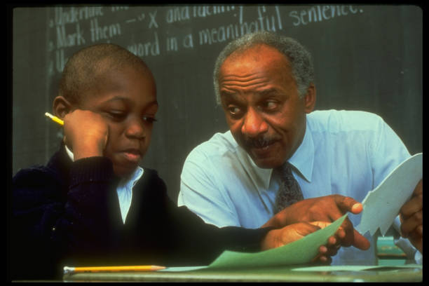 Teacher helping student