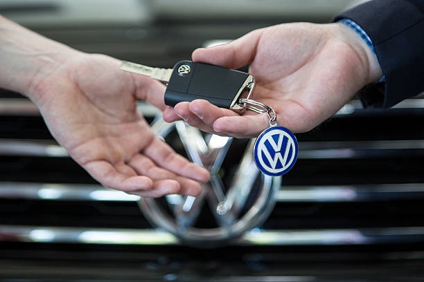 Car salesman handing keys