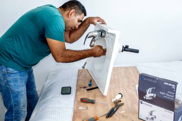 Plumber repairing sink