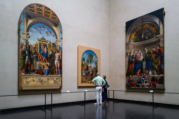 Visitors viewing paintings